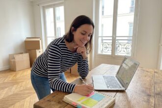 Jeune femme organisée avec checklist de déménagement à Paris